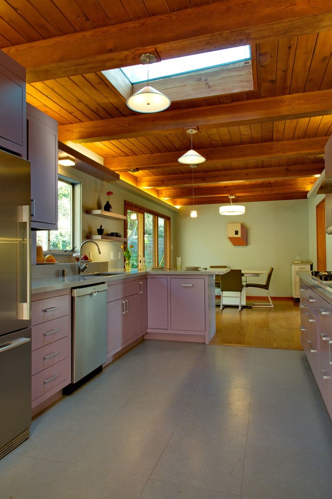 This is an example of a mid-sized contemporary galley eat-in kitchen in San Francisco with an undermount sink, flat-panel cabinets, purple cabinets, quartz benchtops, multi-coloured splashback, glass tile splashback, stainless steel appliances, a peninsula, grey floor and purple benchtop.