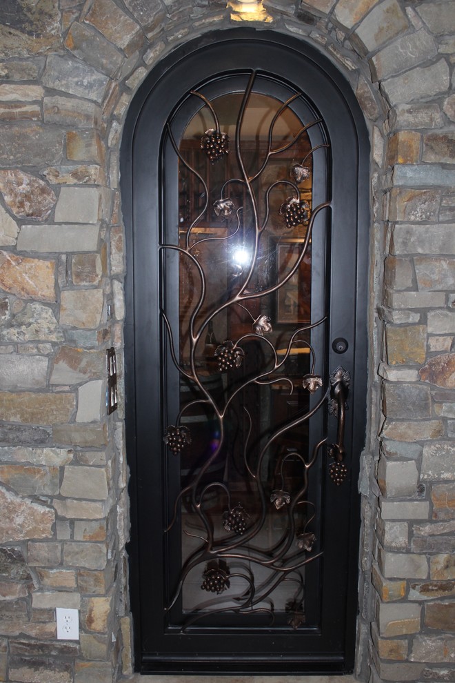 Mid-sized arts and crafts wine cellar in Phoenix with storage racks.