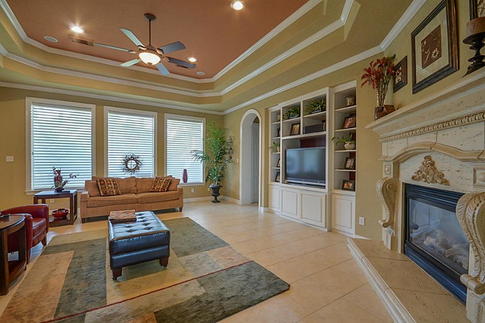 Home design - small transitional home design idea in Houston with a standard fireplace and a stone fireplace