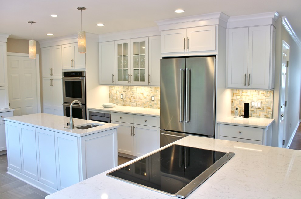 Design ideas for a large transitional kitchen in DC Metro with an undermount sink, white cabinets, beige splashback, stainless steel appliances, multiple islands, shaker cabinets, quartzite benchtops, stone tile splashback, porcelain floors and brown floor.