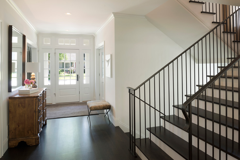 Example of a mid-sized transitional dark wood floor and brown floor hallway design in Minneapolis with white walls