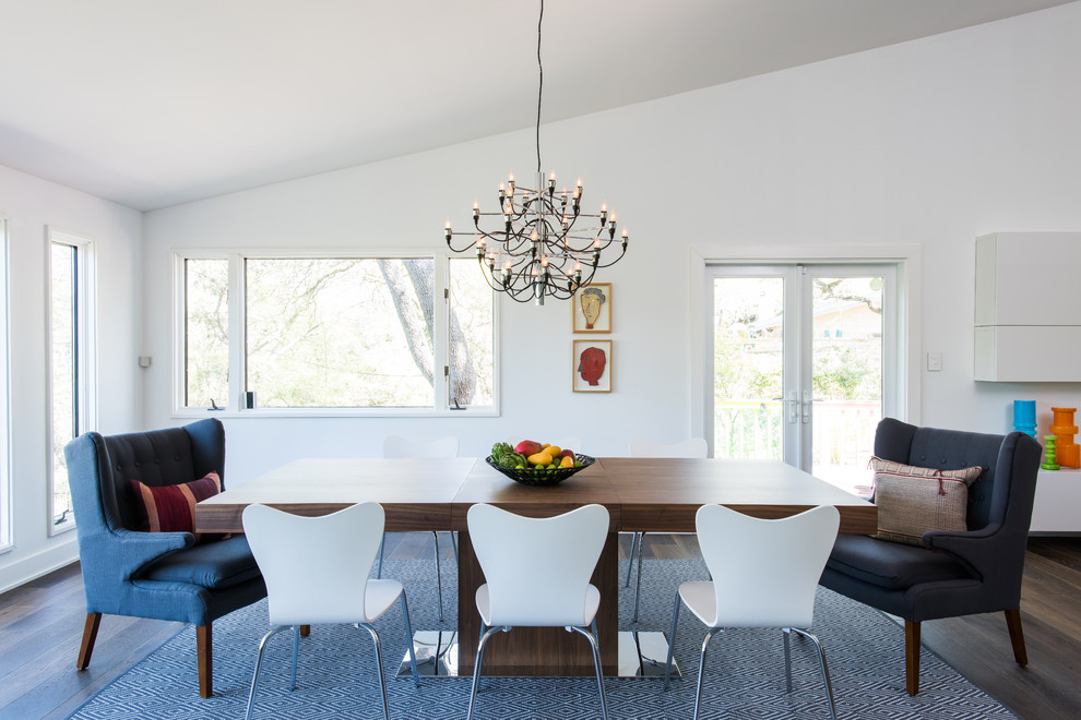 Inspiration for a contemporary dining room in Austin with white walls and dark hardwood floors.