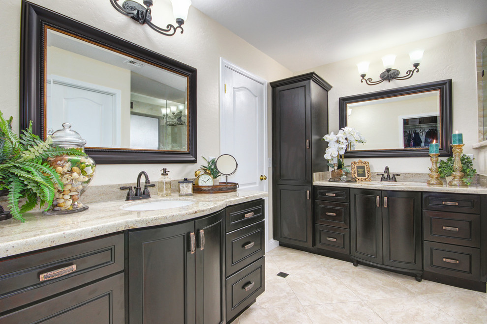 Inspiration for a large contemporary master bathroom in Phoenix with raised-panel cabinets, dark wood cabinets, an alcove shower, beige tile, white tile, stone tile, white walls, porcelain floors, an undermount sink and granite benchtops.