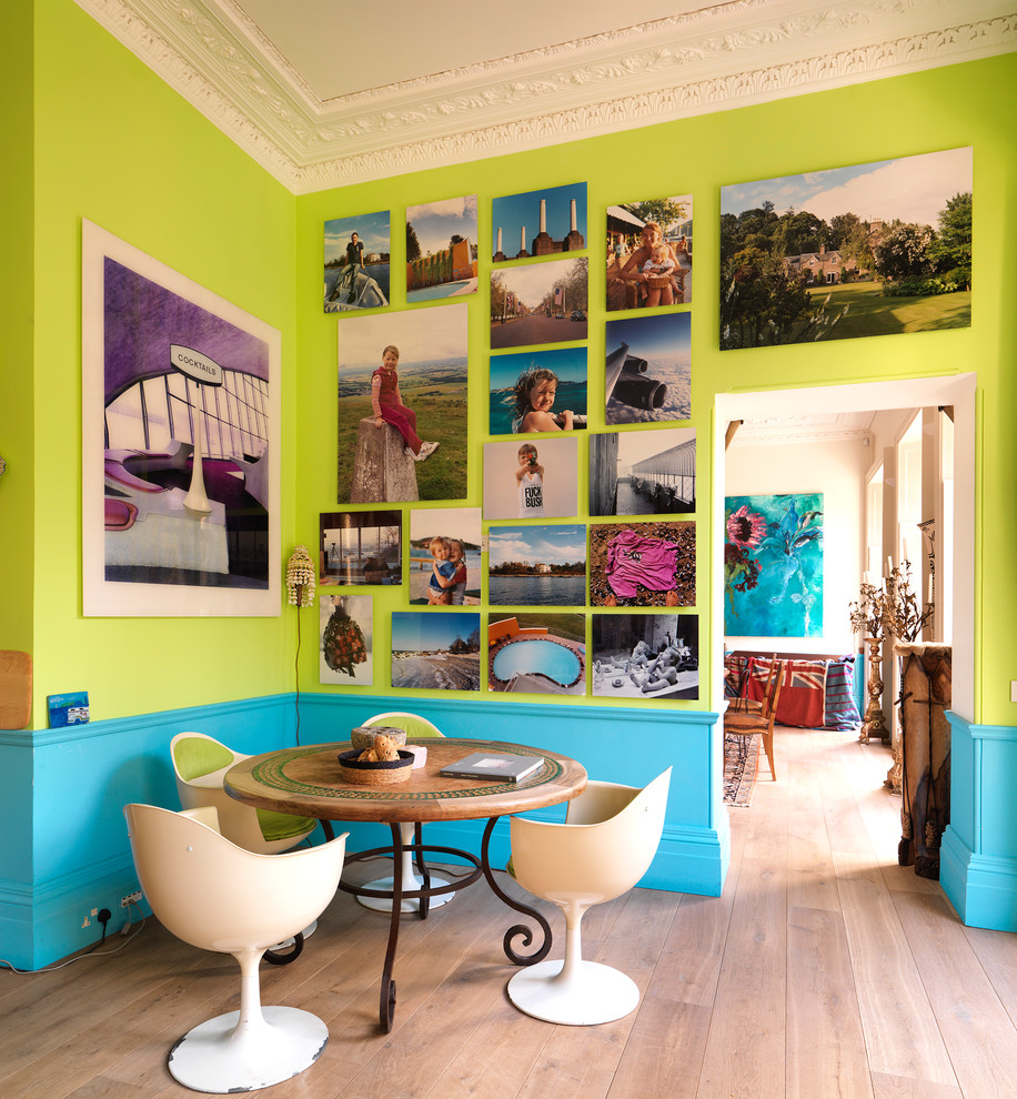 Design ideas for an eclectic dining room in London with multi-coloured walls and light hardwood floors.