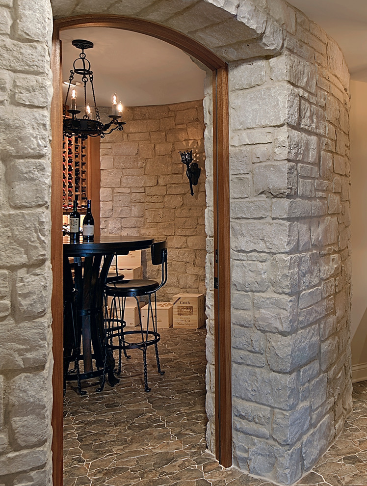 This is an example of a mid-sized mediterranean wine cellar in Milwaukee with ceramic floors, storage racks and brown floor.