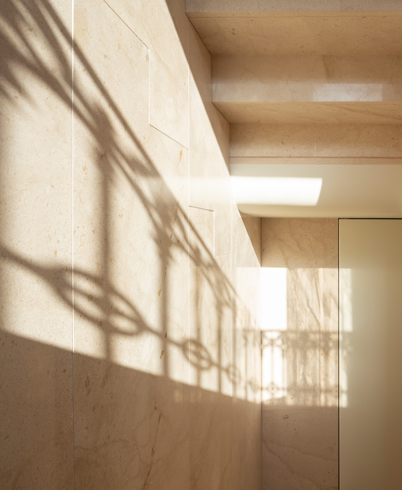 This is an example of a mid-sized contemporary limestone u-shaped staircase in Valencia with limestone risers.