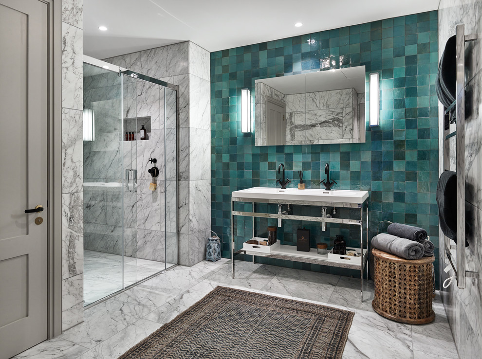 This is an example of a large modern master bathroom in London with open cabinets, an alcove shower, a one-piece toilet, blue tile, terra-cotta tile, white walls, marble floors, a console sink, solid surface benchtops, white floor and a sliding shower screen.