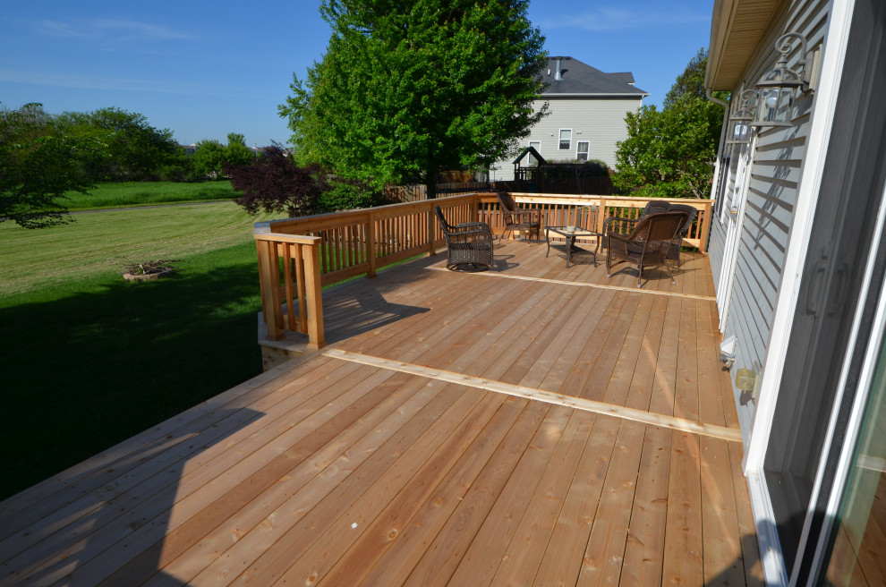 Mid-sized elegant backyard deck photo with no cover