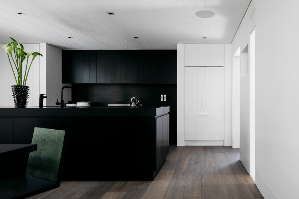 Inspiration for a contemporary galley eat-in kitchen in Sydney with a drop-in sink, shaker cabinets, black cabinets, marble benchtops, black splashback, marble splashback, black appliances, dark hardwood floors, with island, grey floor and black benchtop.