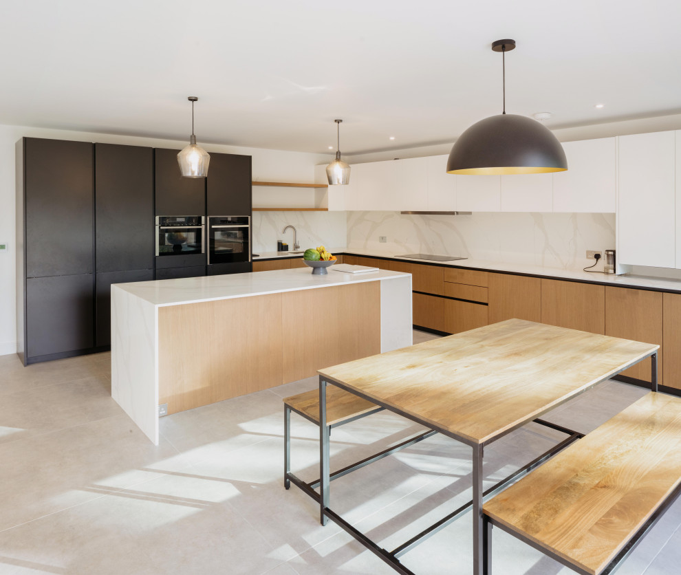Medium sized contemporary l-shaped kitchen/diner in London with a built-in sink, medium wood cabinets, quartz worktops, white splashback, marble splashback, integrated appliances, porcelain flooring, grey floors, white worktops and feature lighting.