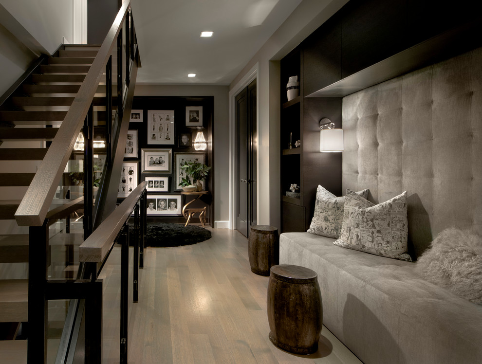 This is an example of a contemporary hallway in Chicago with grey walls and medium hardwood floors.