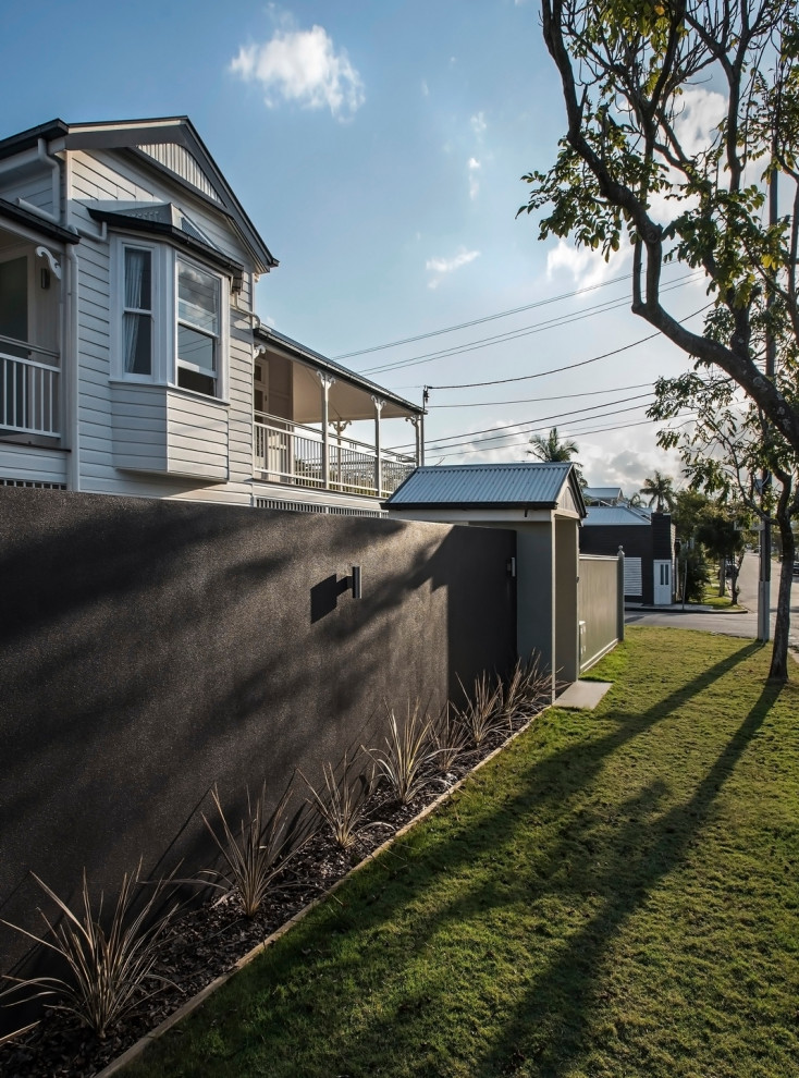 Photo of a contemporary two-storey house exterior with mixed siding, a gable roof and a metal roof.