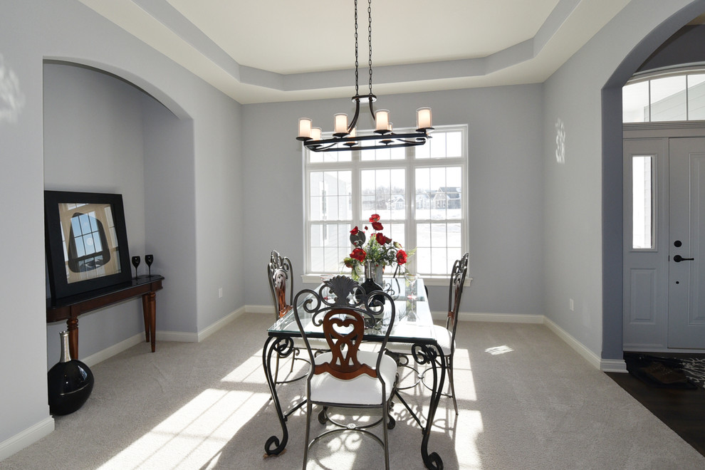 Photo of a mid-sized traditional separate dining room in Milwaukee with grey walls and carpet.