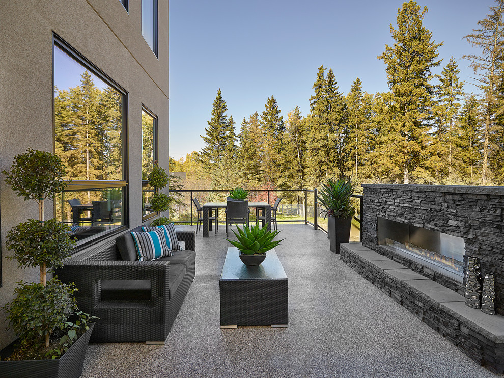Deck - mid-sized transitional backyard deck idea in Edmonton with a fire pit and no cover