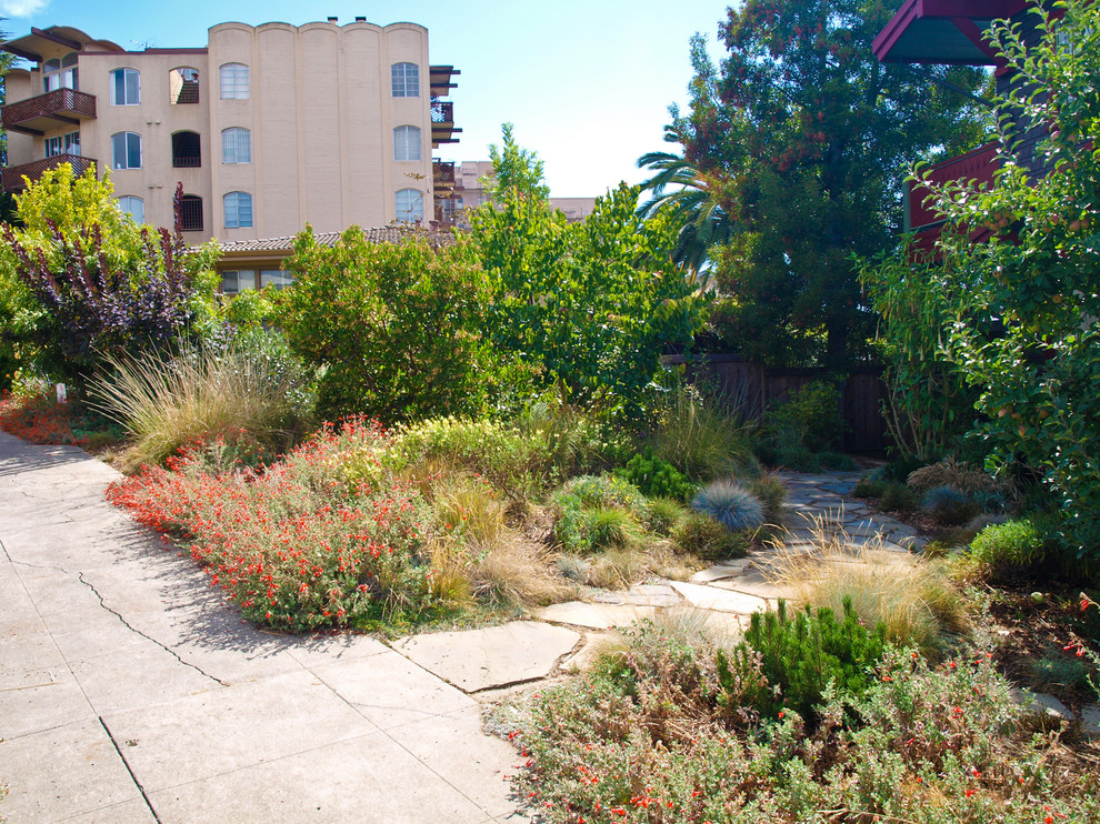 This is an example of a mid-sized traditional partial sun backyard stone formal garden in San Francisco for summer.