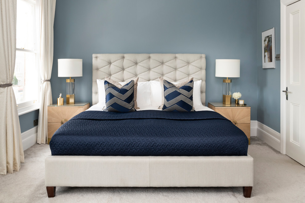 Design ideas for a contemporary master bedroom in London with blue walls, carpet and beige floor.