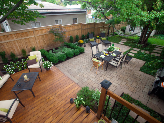 Large traditional backyard patio in Montreal with brick pavers, no cover and a fire feature.