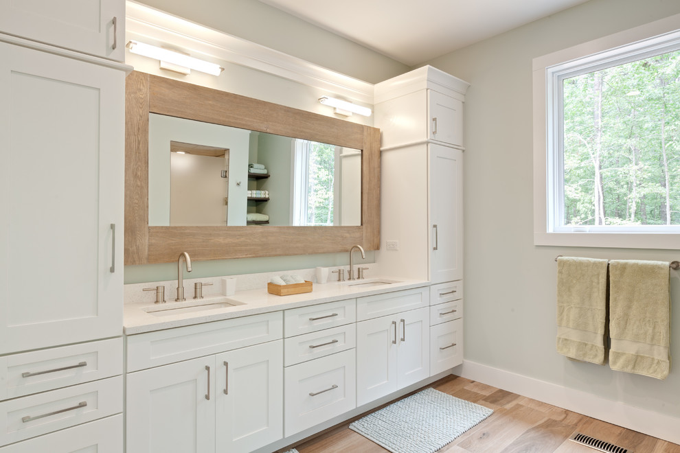 Photo of a large contemporary master bathroom in Atlanta with shaker cabinets, white cabinets, engineered quartz benchtops, a freestanding tub, an alcove shower, beige tile, blue walls, wood-look tile, an undermount sink, beige floor, a hinged shower door, white benchtops, a double vanity and a built-in vanity.