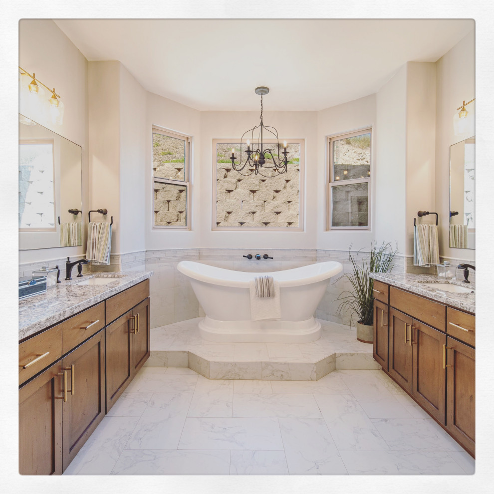 Design ideas for an expansive mediterranean master bathroom in Los Angeles with shaker cabinets, light wood cabinets, a freestanding tub, an open shower, a one-piece toilet, beige tile, porcelain tile, beige walls, porcelain floors, an undermount sink, granite benchtops, white floor, an open shower, multi-coloured benchtops, an enclosed toilet, a double vanity, a built-in vanity and decorative wall panelling.