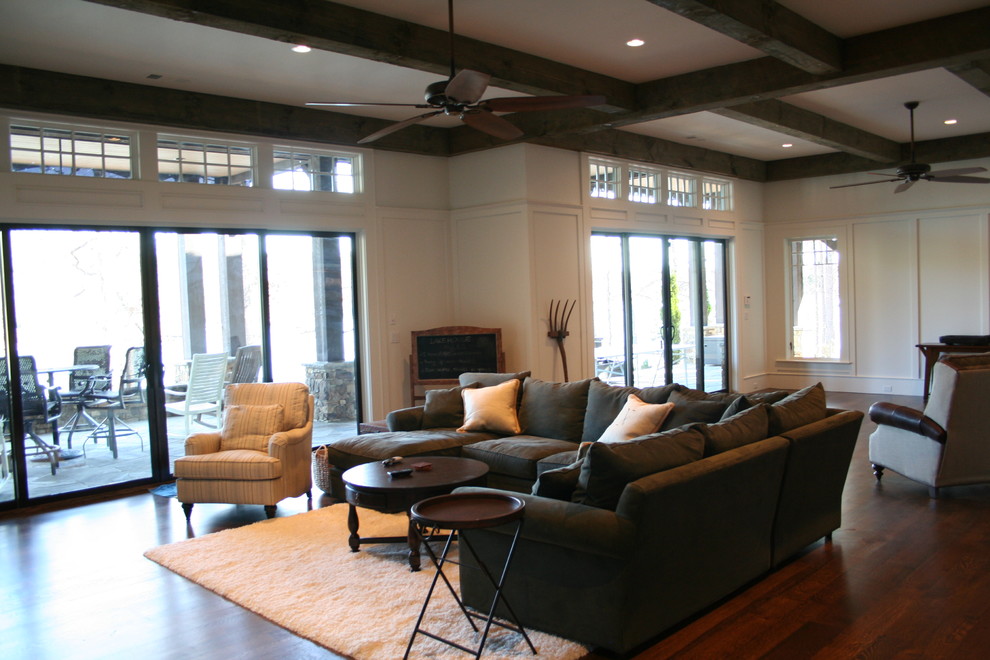 Photo of a traditional formal open concept living room in Atlanta with white walls, dark hardwood floors, no fireplace and a freestanding tv.
