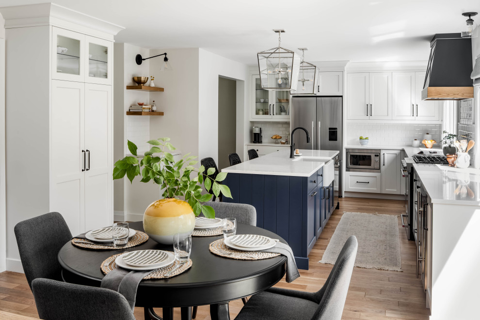 Large transitional l-shaped kitchen photo in Toronto with shaker cabinets and an island