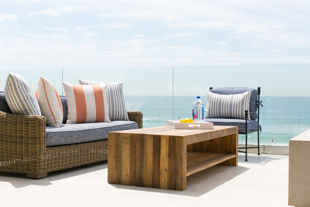 Photo of a mid-sized beach style rooftop deck in Orange County with no cover and a fire feature.