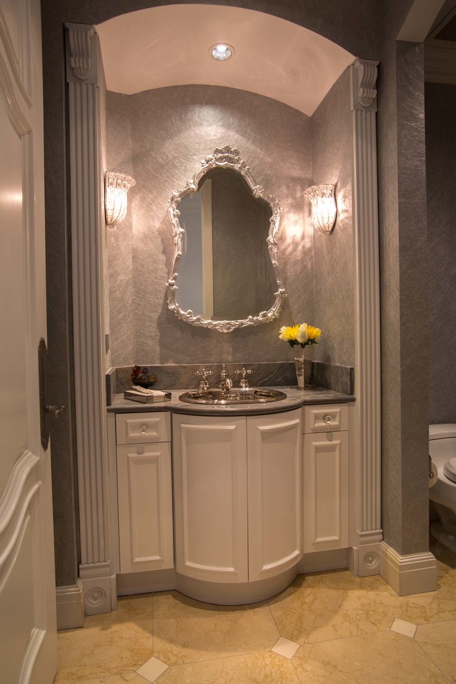 Inspiration for a traditional powder room in Miami with a drop-in sink.
