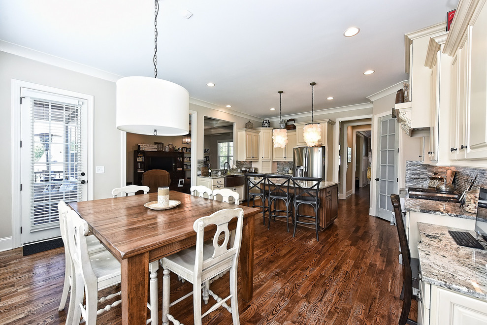 Large transitional dark wood floor and brown floor kitchen/dining room combo photo with white walls