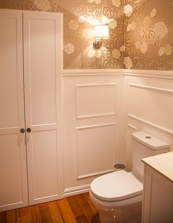 Inspiration for a small traditional powder room in Melbourne with an undermount sink, shaker cabinets, white cabinets, engineered quartz benchtops, porcelain tile, beige walls, medium hardwood floors and a two-piece toilet.