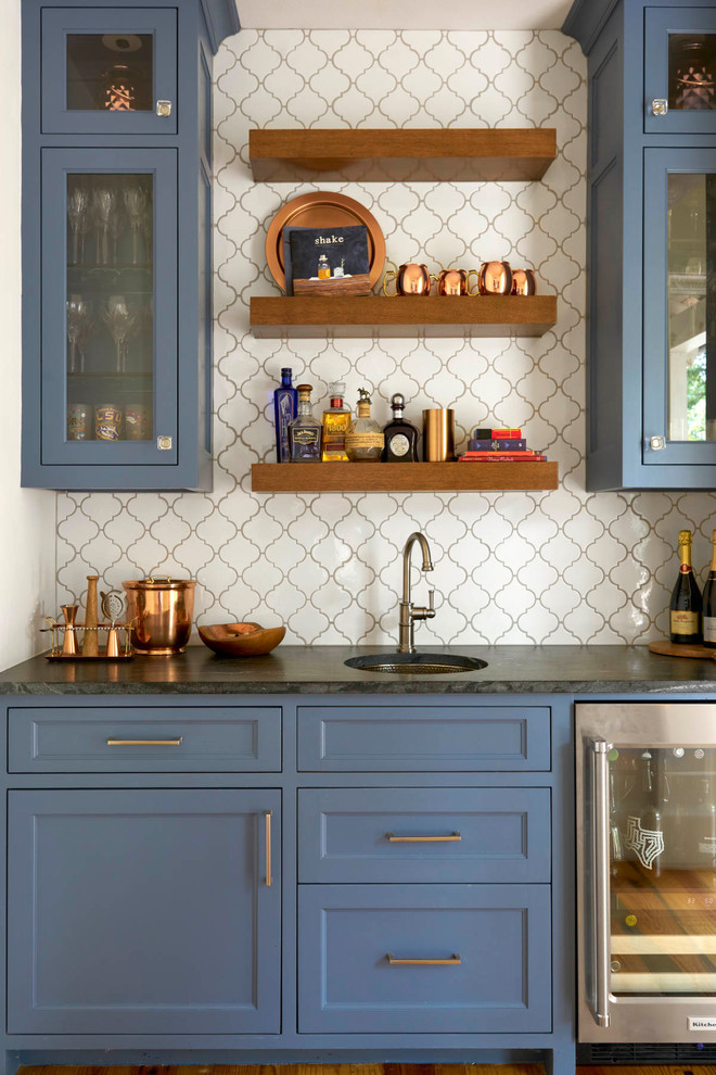 Design ideas for a country single-wall wet bar in Dallas with an undermount sink, blue cabinets, white splashback and glass-front cabinets.