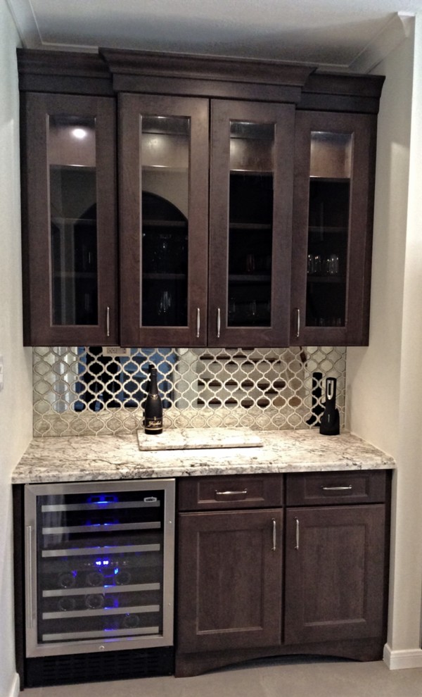 Eat-in kitchen - mid-sized transitional u-shaped ceramic tile eat-in kitchen idea in Houston with a farmhouse sink, recessed-panel cabinets, white cabinets, granite countertops, white backsplash, stone tile backsplash, stainless steel appliances and an island