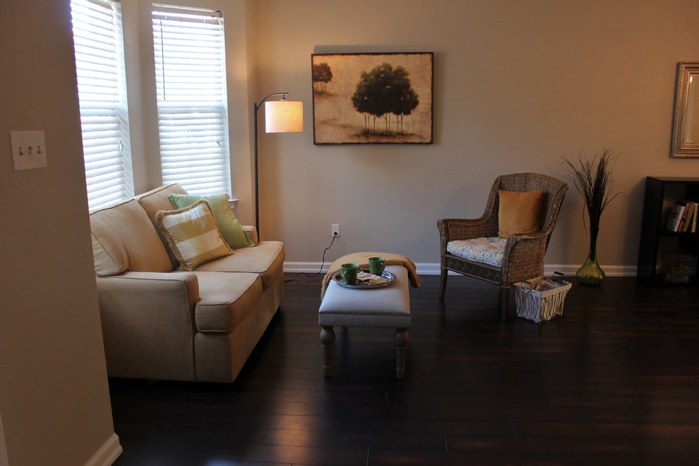 This is an example of a small transitional open concept living room in Other with grey walls and laminate floors.