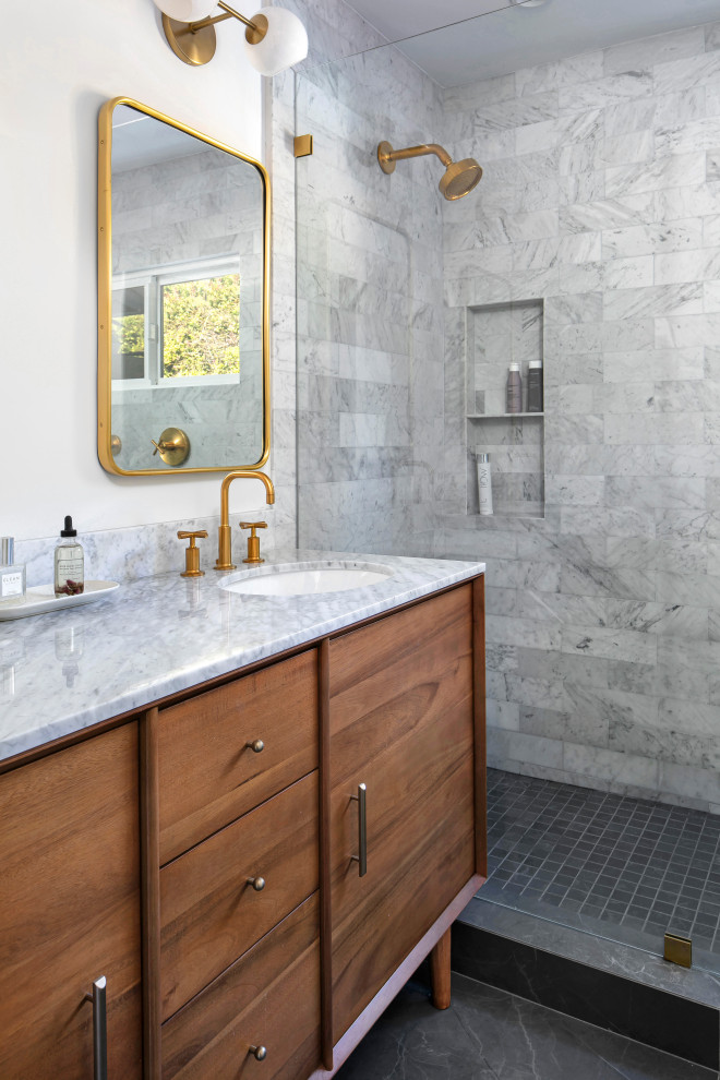 Design ideas for a mid-sized transitional master bathroom in Los Angeles with flat-panel cabinets, medium wood cabinets, an alcove shower, a wall-mount toilet, multi-coloured tile, marble, white walls, porcelain floors, an undermount sink, marble benchtops, black floor, a hinged shower door, multi-coloured benchtops, a shower seat, a double vanity and a freestanding vanity.