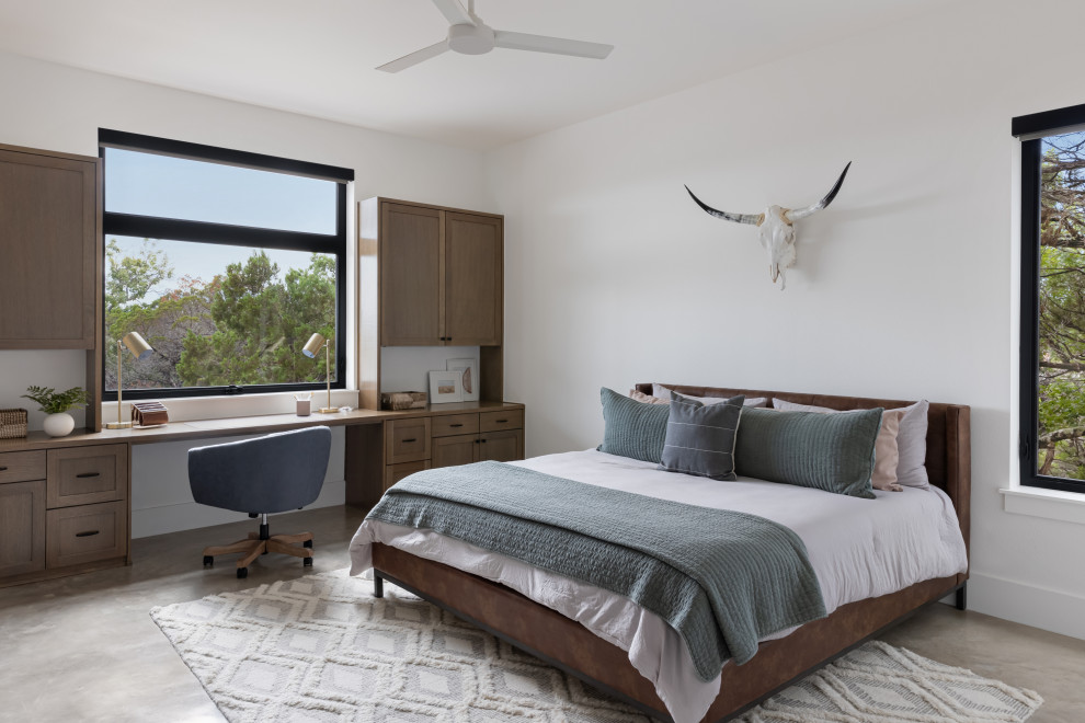Mid-sized scandinavian guest bedroom in Austin with white walls, concrete floors and beige floor.