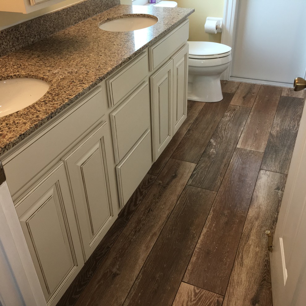 Wood grain porcelain tile with a stone pebble deco and floor. Orlando