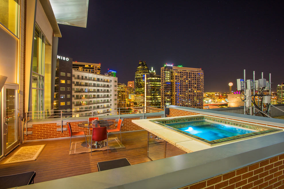 Photo of a small contemporary rooftop pool in Dallas with a hot tub.