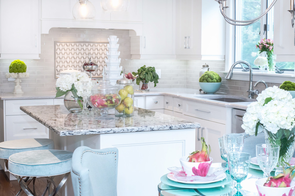 Eat-in kitchen - mid-sized transitional u-shaped eat-in kitchen idea in Toronto with shaker cabinets, white cabinets, white backsplash, an island, quartz countertops and stainless steel appliances