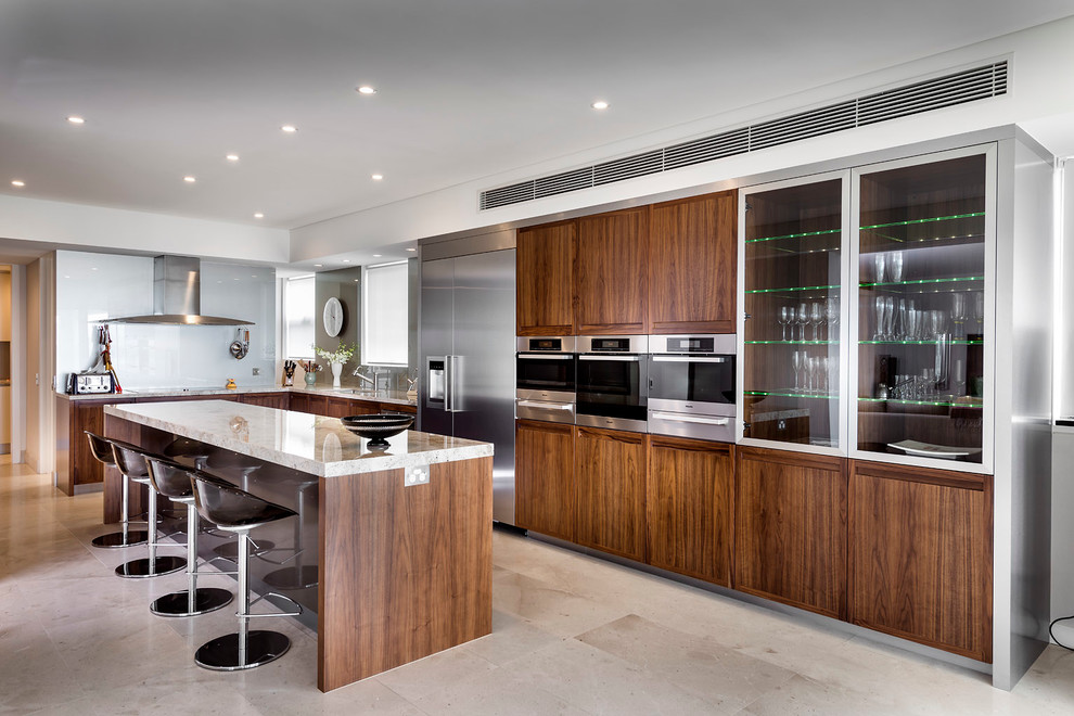 This is an example of a modern kitchen in Perth with dark wood cabinets, white splashback, glass sheet splashback, stainless steel appliances and with island.