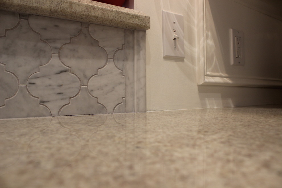 Example of a mid-sized transitional u-shaped ceramic tile enclosed kitchen design in Phoenix with a double-bowl sink, raised-panel cabinets, white cabinets, marble countertops, gray backsplash, ceramic backsplash, stainless steel appliances and an island