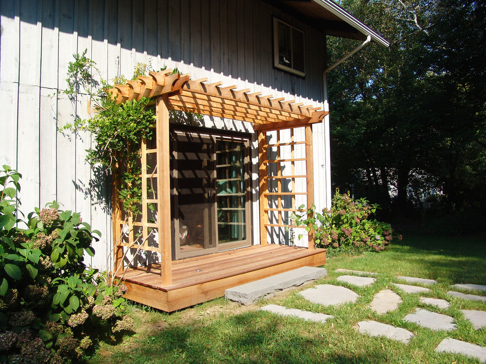 Photo of a small traditional backyard verandah in Providence with decking and a pergola.