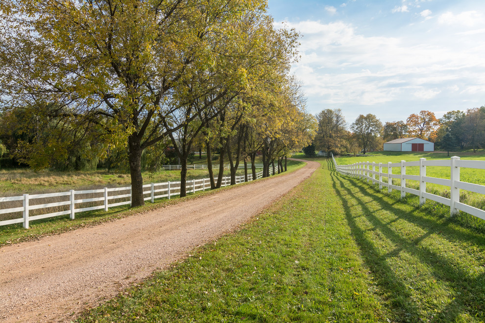 Inspiration for a large country front yard partial sun driveway in Minneapolis.