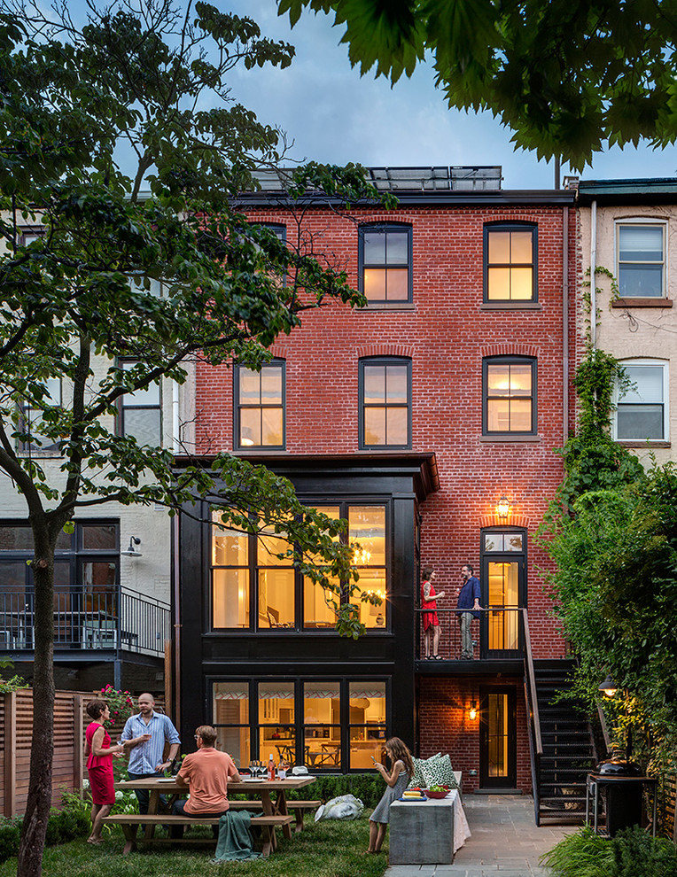 Traditional three-storey brick townhouse exterior in New York.