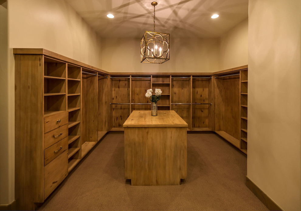 Inspiration for a mid-sized transitional women's walk-in wardrobe in Other with flat-panel cabinets, light wood cabinets and carpet.