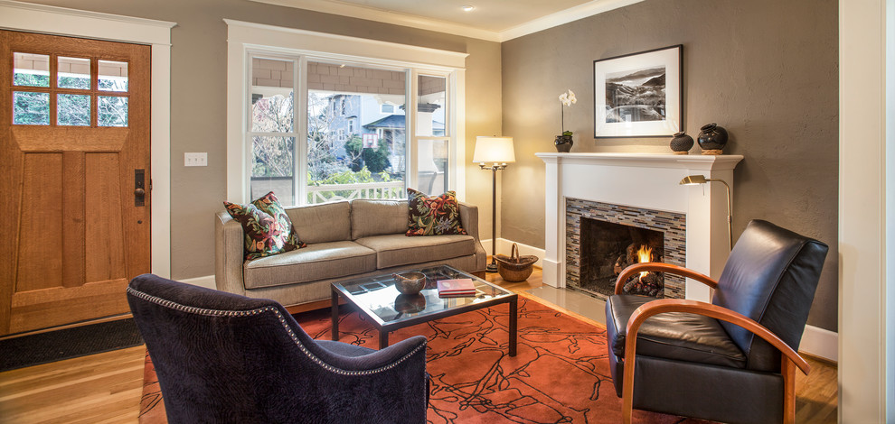 Photo of a mid-sized arts and crafts formal open concept living room in Portland with grey walls, light hardwood floors, a standard fireplace, a tile fireplace surround and no tv.