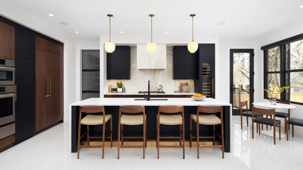 Contemporary l-shaped kitchen/diner in Calgary with a submerged sink, flat-panel cabinets, black cabinets, white splashback, stone slab splashback, an island, white floors and white worktops.