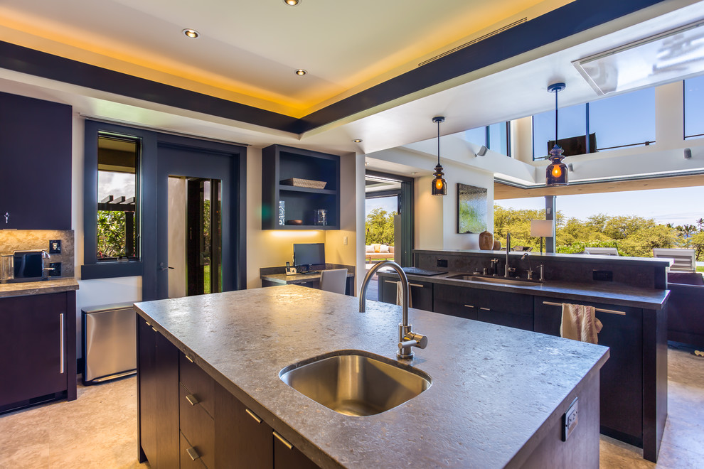 Photo of a large contemporary single-wall eat-in kitchen in Hawaii with an undermount sink, flat-panel cabinets, dark wood cabinets, soapstone benchtops, grey splashback, stone slab splashback, panelled appliances, marble floors and multiple islands.