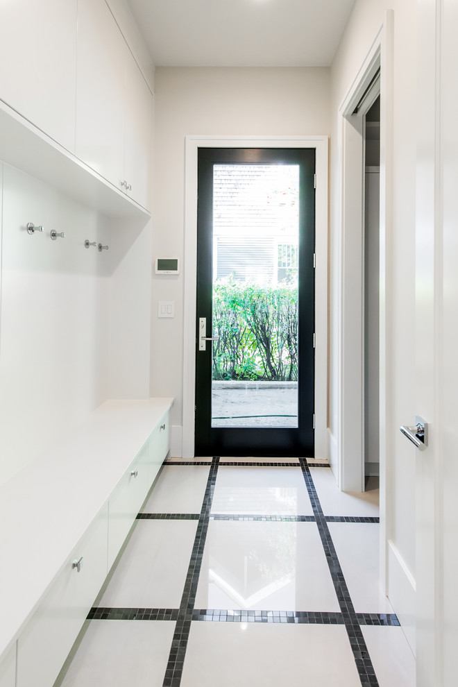 Large transitional gender-neutral ceramic tile entryway photo in Calgary with white cabinets