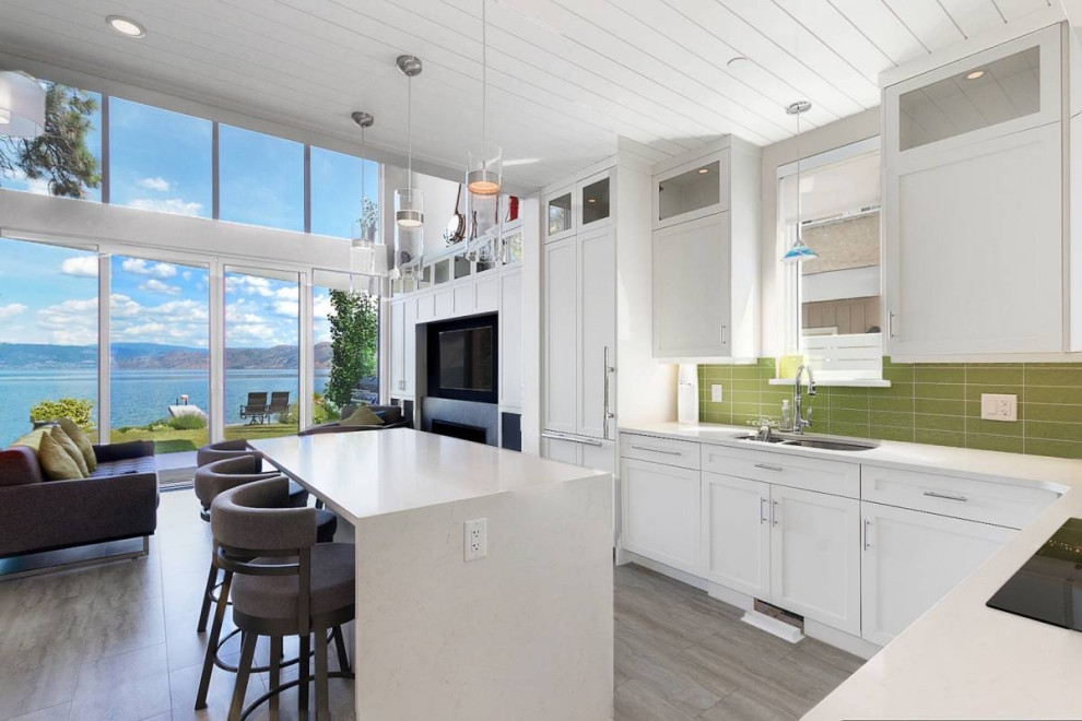 Inspiration for a small beach style l-shaped eat-in kitchen in Vancouver with an undermount sink, shaker cabinets, white cabinets, quartzite benchtops, green splashback, glass tile splashback, panelled appliances, vinyl floors, with island, grey floor, white benchtop and timber.