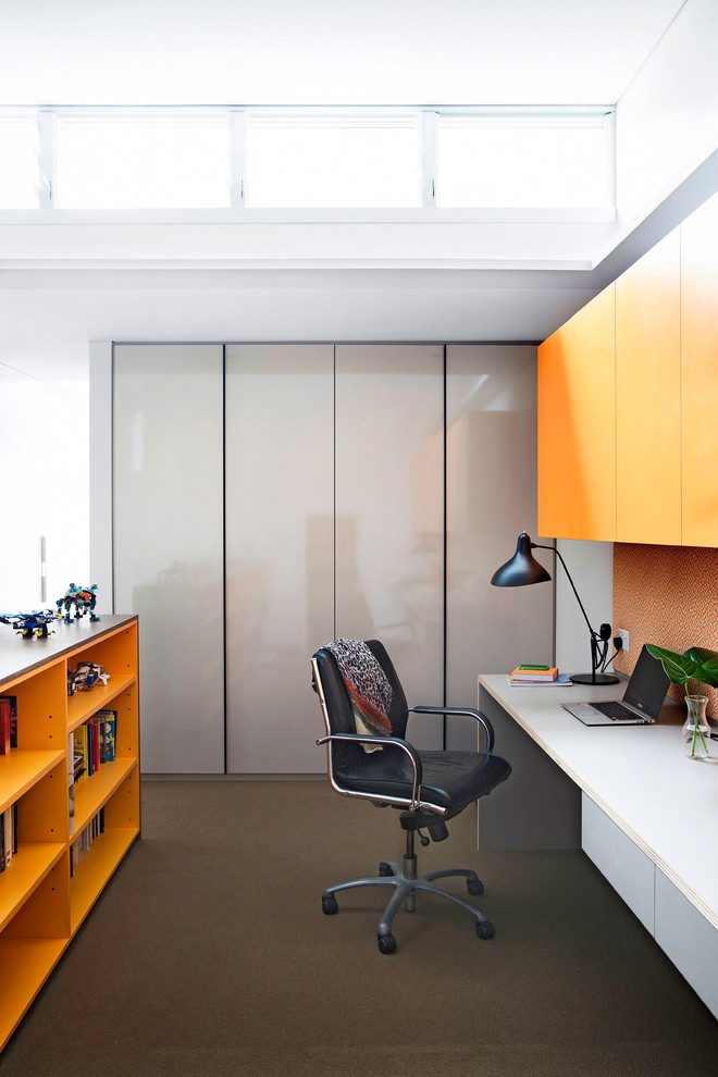 Photo of a mid-sized contemporary study room in Sydney with white walls, carpet and a built-in desk.