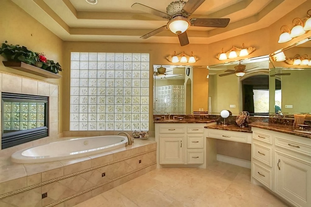 Inspiration for a large traditional master bathroom in Houston with white cabinets.